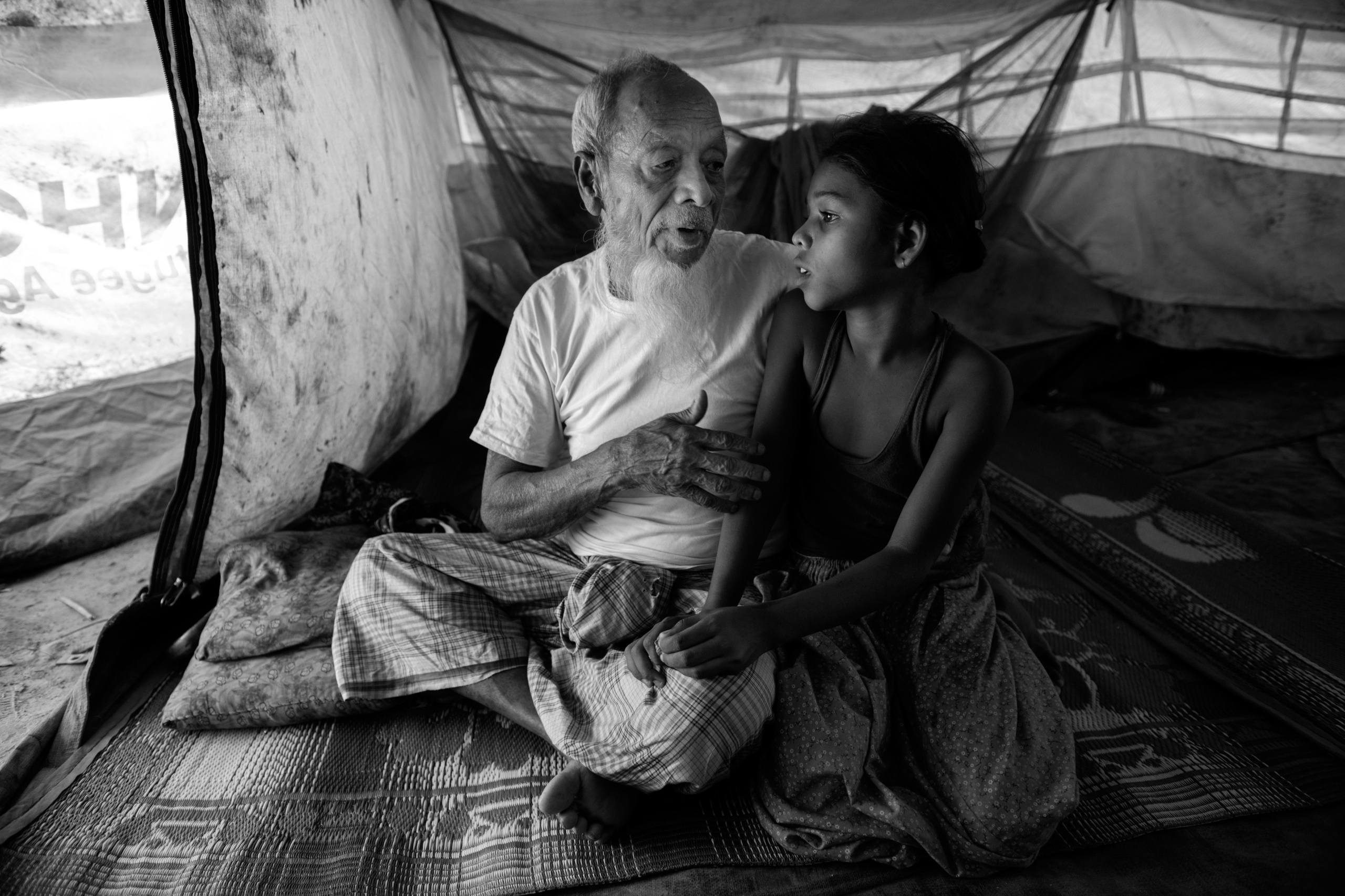 Bangladesh, Cox's Bazaar.
A 90-year-old Rohingya refugee talks with his granddaughter. They walked more than 7 days before crossing the border at the Kutupalong transit center .Over 650,000 Rohingya have crossed the border to Bangladesh since August last year, fleeing the violence.