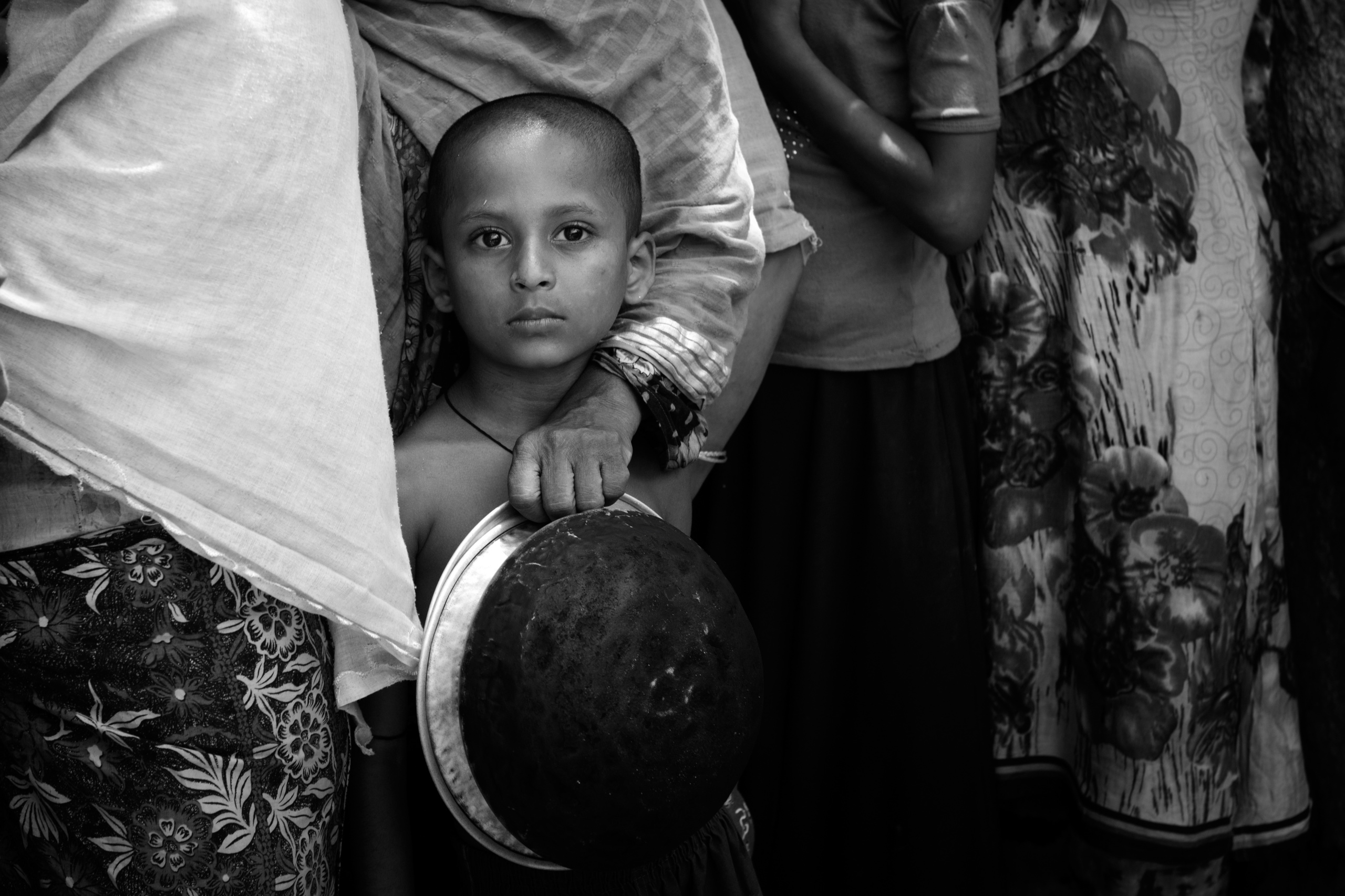 Bangladesh, Cox's Bazaar.
Rohingya refugees wait for food distribution at the Kutupalong transit center . Over 650,000 Rohingya have crossed the border to Bangladesh since August last year, fleeing the violence.