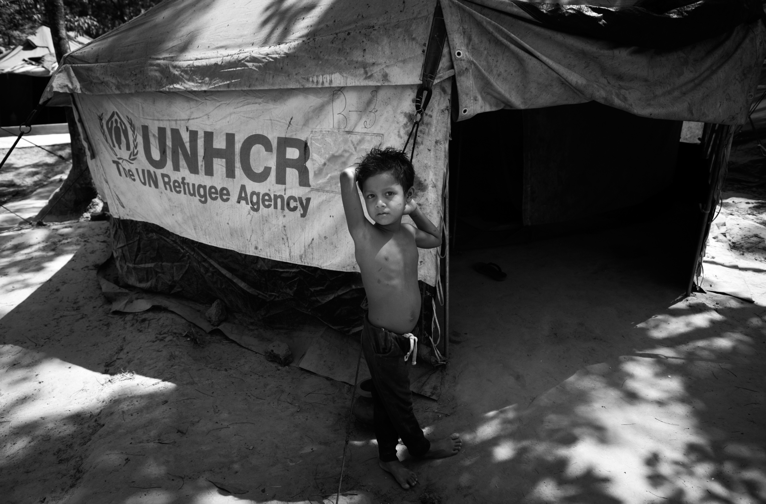 Bangladesh, Cox's Bazaar.
Rohingya child poses in front UNHCR tent.
Over 650,000 Rohingya have crossed the border to Bangladesh since August last year, fleeing the violence.