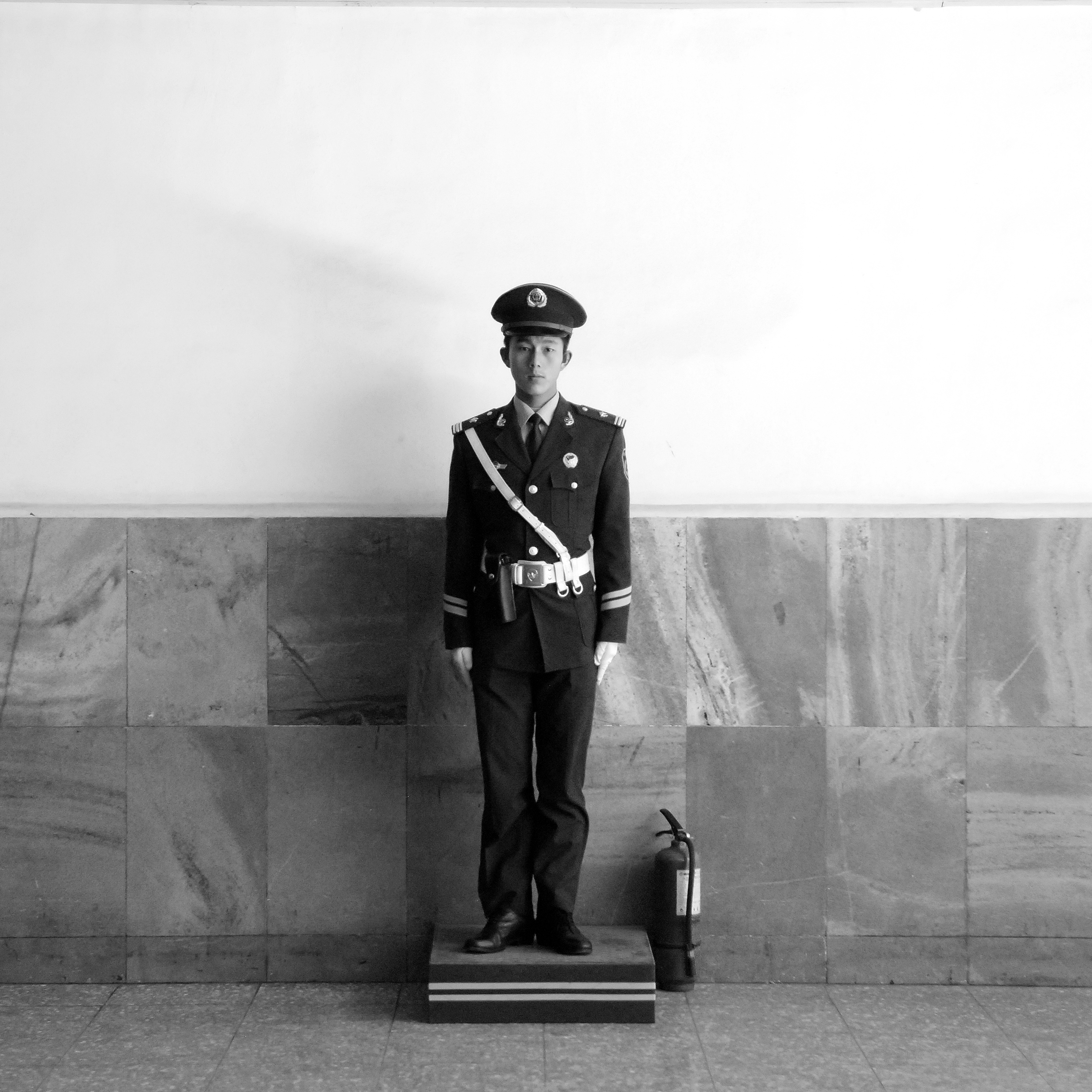 Beijing, China.
A policeman guards the subway entrance to Tiananmen Square during the daily sunrise flag-raising ceremony
