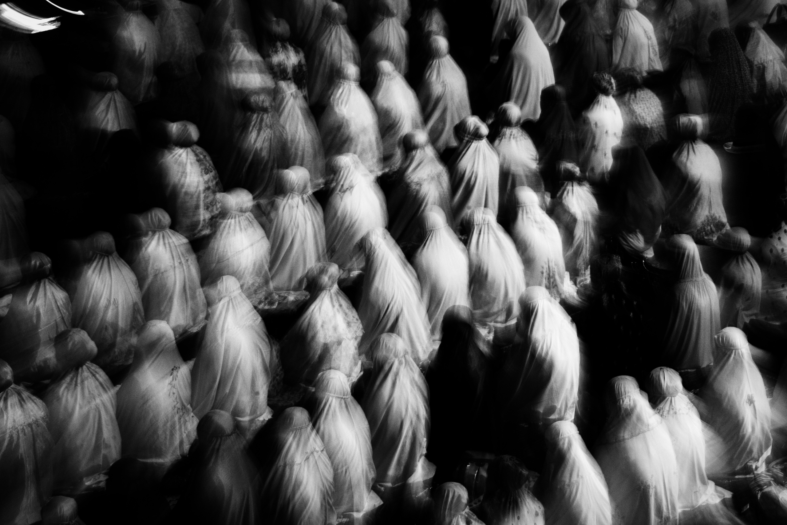 Indonesian Muslims women perform an evening prayer. Jakarta, Indonesia.
