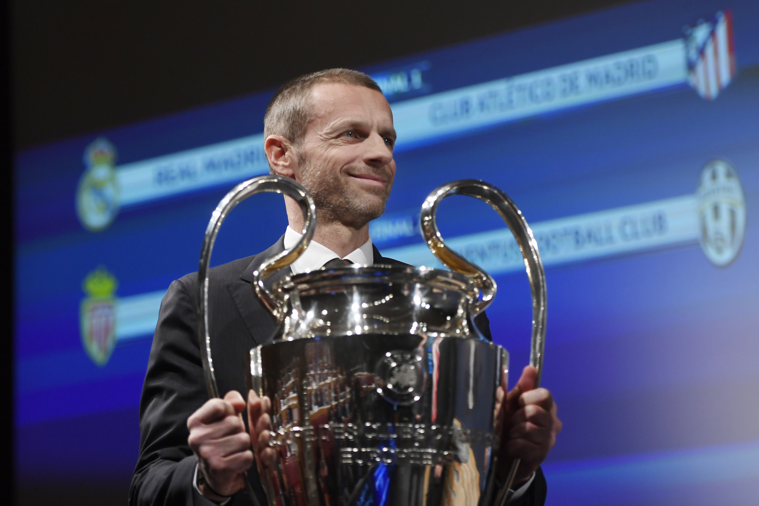 UEFA president Aleksander Ceferin hands over the Champions League trophy ahead of the UEFA football Champion's league semi-finals draw on April 21, 2017 in Nyon. / AFP PHOTO / Richard Juilliart (Photo credit should read RICHARD JUILLIART/AFP/Getty Images)