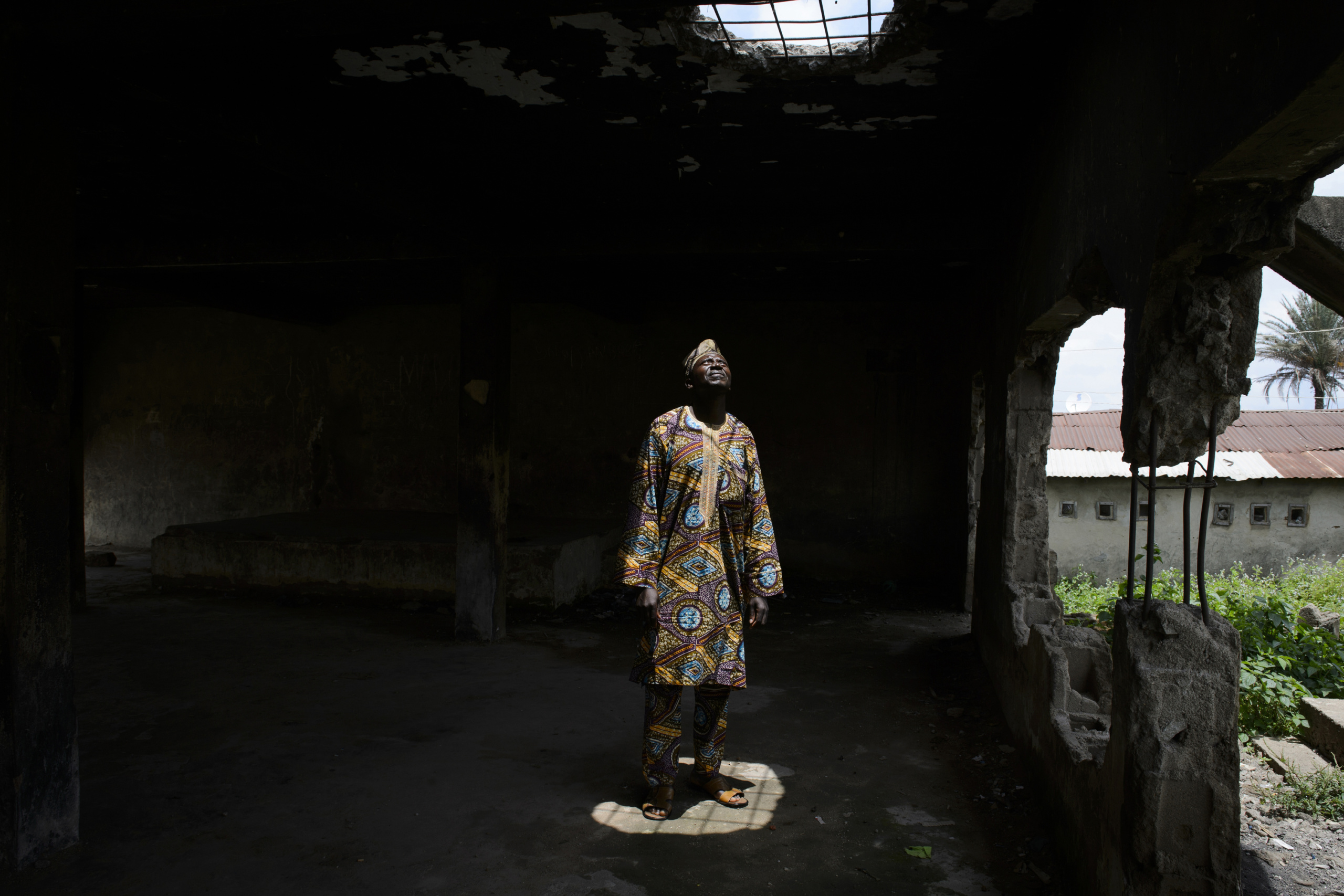 NIGERIA,Kaduna.
A man posing inside a church destroyed during inter-religious confrontations in a Muslim district of Kaduna.
Nearly 4,000 people have died in Nigeria due to the violent conflict over the past decade.
The economic and ethnic conflict in the northern states has a religious dimension. It is only with true governance that these conflicting differences could be managed. As elsewhere in Nigeria, residents accuse both local and state government officials for promoting identity-based divisions to advance their own political agendas.