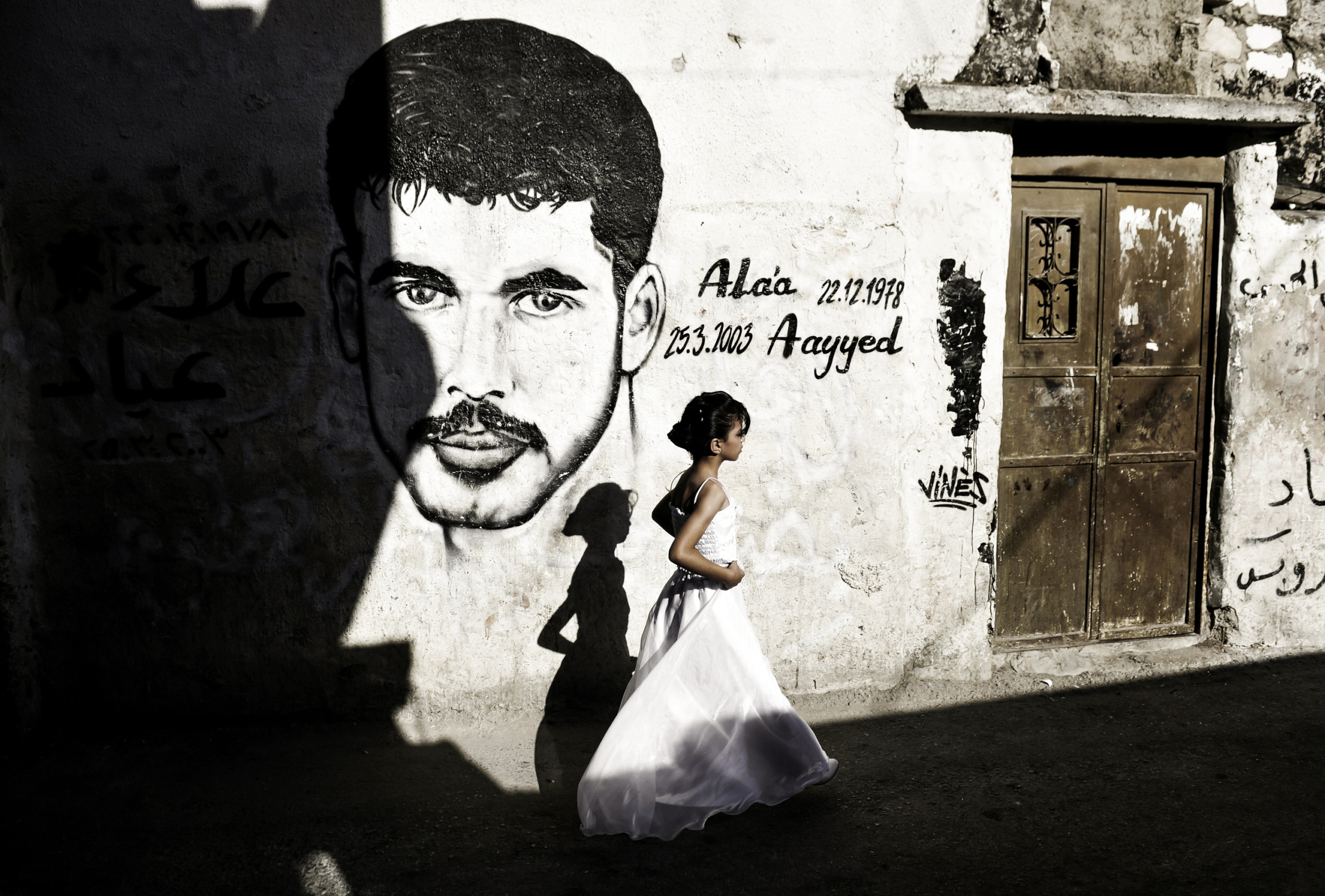 Palestine,Bethlehem: A young woman walking in Deheishe refugee camp.