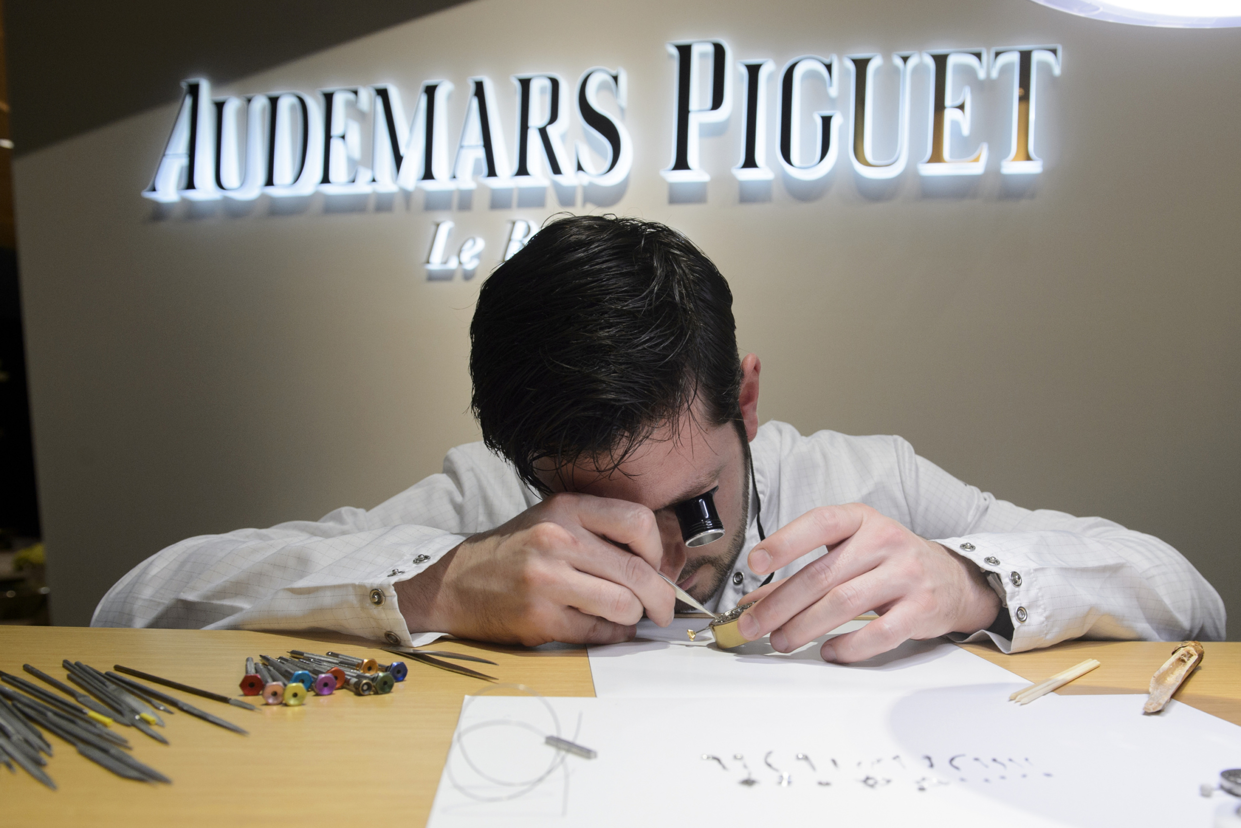 An employe of Swiss watchmaker Audemars Piguet checks a wristwatch during the opening day of the 'Salon International de la Haute Horlogerie' (SIHH), a professional fair in fine watchmaking, on January 18, 2016. / AFP / Richard Juilliart (Photo credit should read RICHARD JUILLIART/AFP/Getty Images)