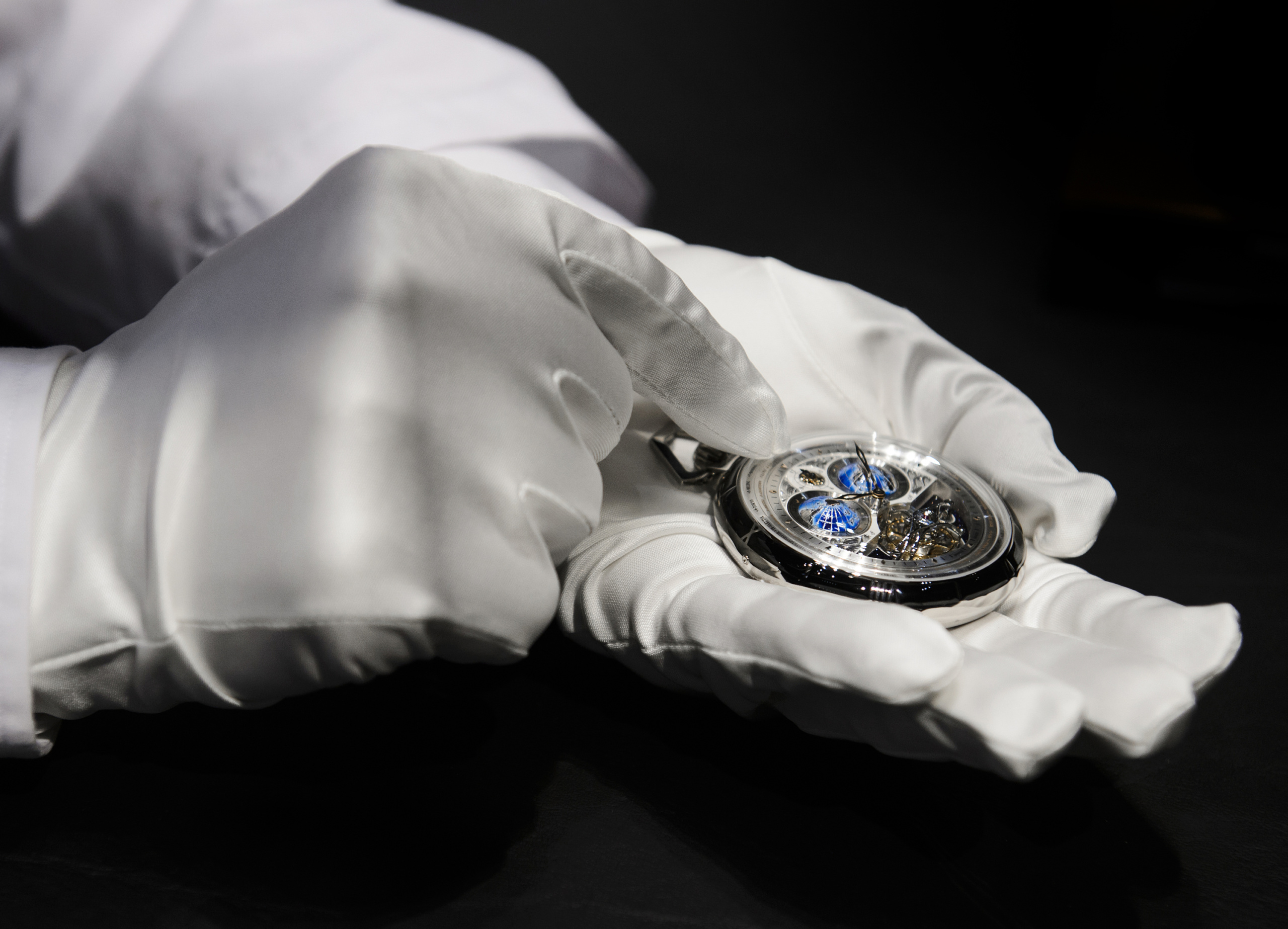 An employee shows a Montblanc watch, owned by Richemont, a Switzerland-based luxury goods holding company, during the opening day of the 'Salon International de la Haute Horlogerie' (SIHH), a professional fair in fine watchmaking in Geneva, on January 18, 2016. / AFP / Richard Juilliart