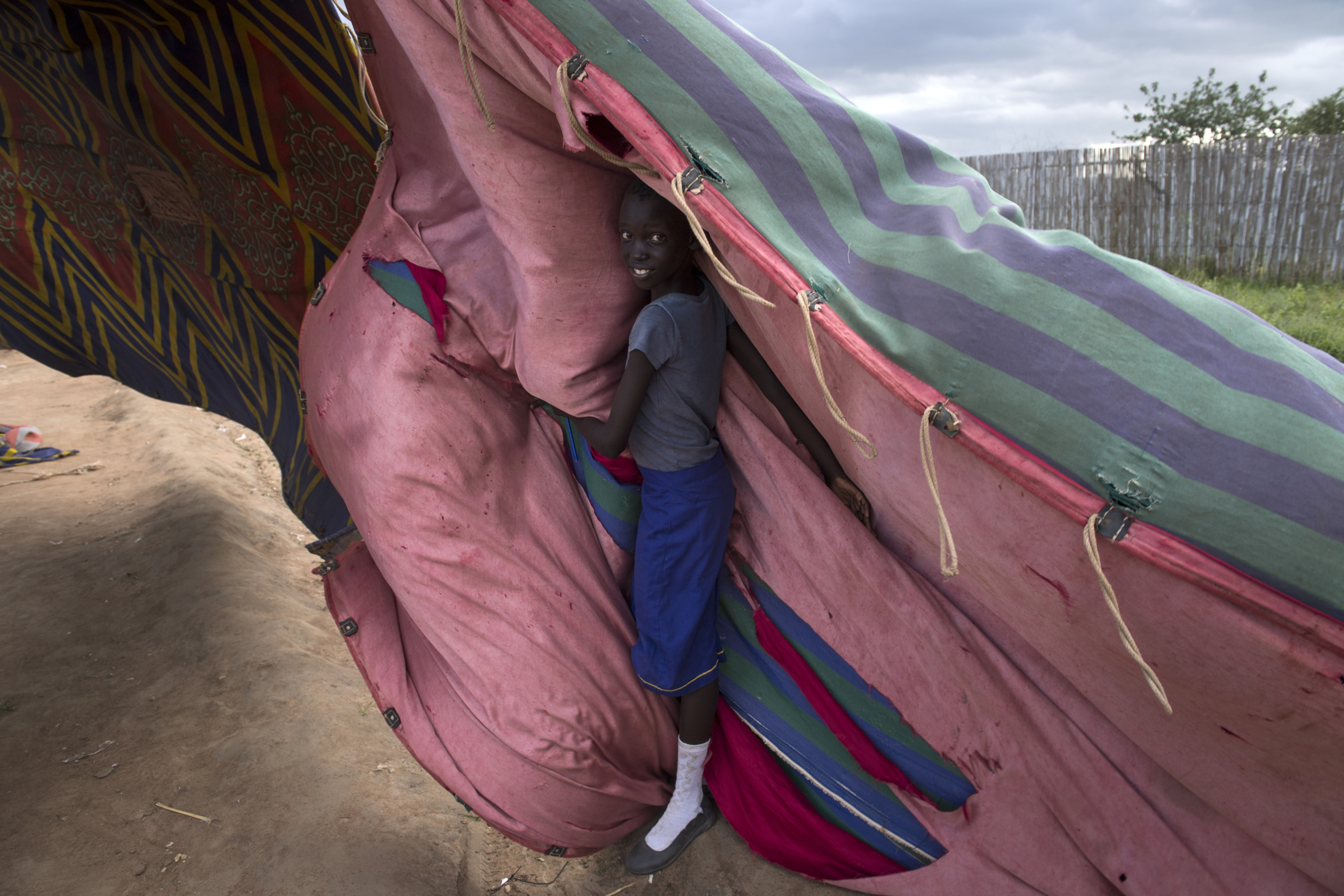 South Sudan, Juba.
A woman attempts of protect herself from strong wind .