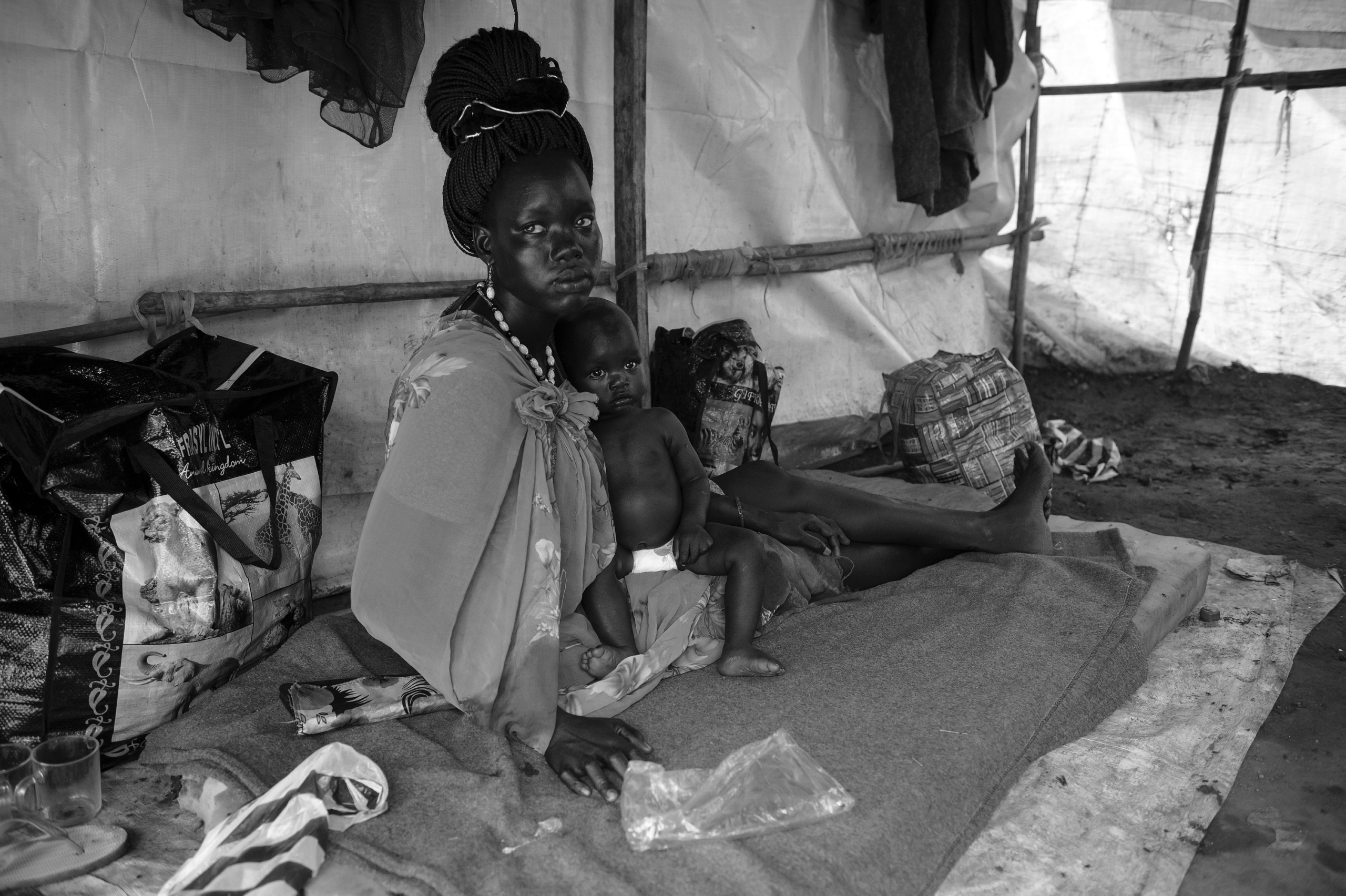 — SOUTH SUDAN
Juba, South Sudan.
Displaced persons from Dinka ethnic group are sheltered in a refugee camp under control of UN at Juba.
On 9th of July 2011 a new country will be born in Africa. The Republic of South Sudan will be the 54th African state and the 193rd nation in the world. But South Sudan is a very poor country, despite its large oil reserves, which account for 98 percent of its income.
South Sudan’s society is deeply divided along tribal lines. The main clan is the Dinka, a pastoral semi-nomadic population. Violence is endemic to the region, often as a consequences of cattle ownership issues. But violence is also very much fed by the uncountable number of weapons circulating in the country, the heavy legacy of a 30 year long civil war against North Sudan.