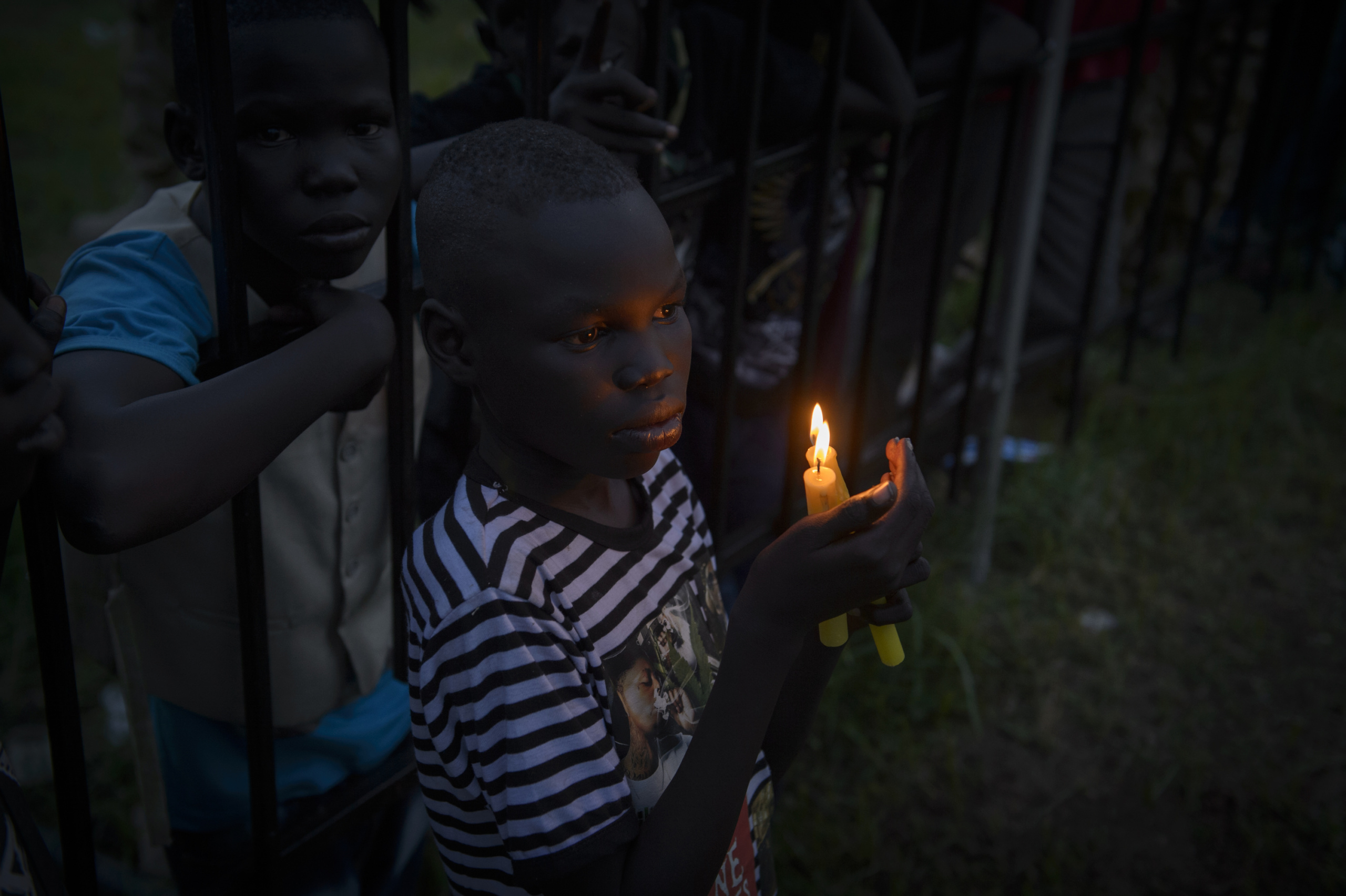 — SOUTH SUDAN
Juba, South Sudan.
South Sudanese boy hold candles as the clock ticks over to midnight to commemorate the day that South Sudan will officially declare independence from the north.
On 9th of July 2011 a new country will be born in Africa. The Republic of South Sudan will be the 54th African state and the 193rd nation in the world. But South Sudan is a very poor country, despite its large oil reserves, which account for 98 percent of its income.
South Sudan’s society is deeply divided along tribal lines. The main clan is the Dinka, a pastoral semi-nomadic population. Violence is endemic to the region, often as a consequences of cattle ownership issues. But violence is also very much fed by the uncountable number of weapons circulating in the country, the heavy legacy of a 30 year long civil war against North Sudan.