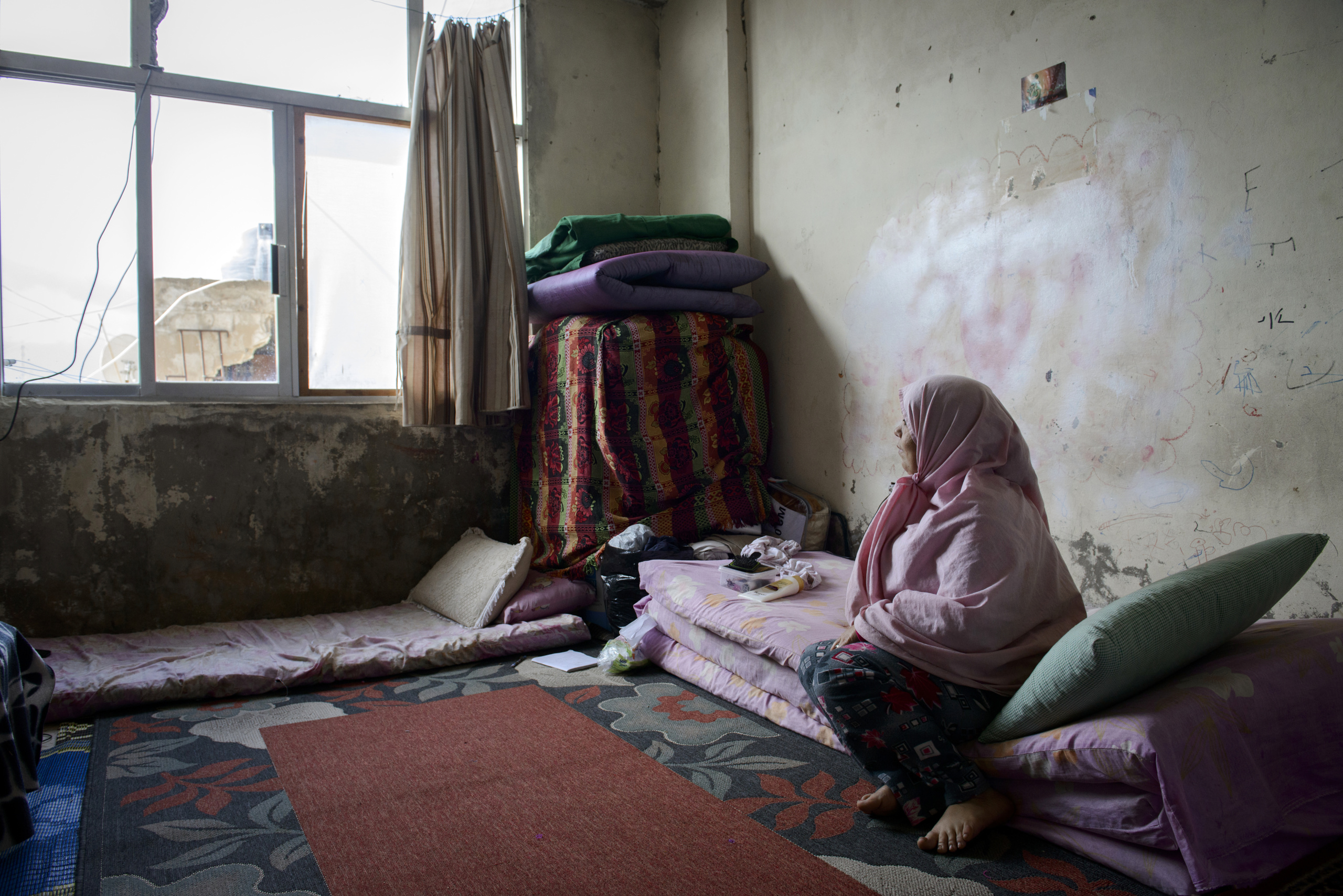 Saida-Lebanon.
A woman on his room inside an abandoned construction site occupied by Syrian refugees.This building is located in the center of Saida . The owner gave access electricity and water free of charge to refugees. . The refugees try to survive through public subsidies and underpaid labor.
the Lebanese government will not allow traditional refugee camps in Lebanon, refugees are finding unusual places to live across the country, including unfinished homes, abandoned shopping malls and schools .......