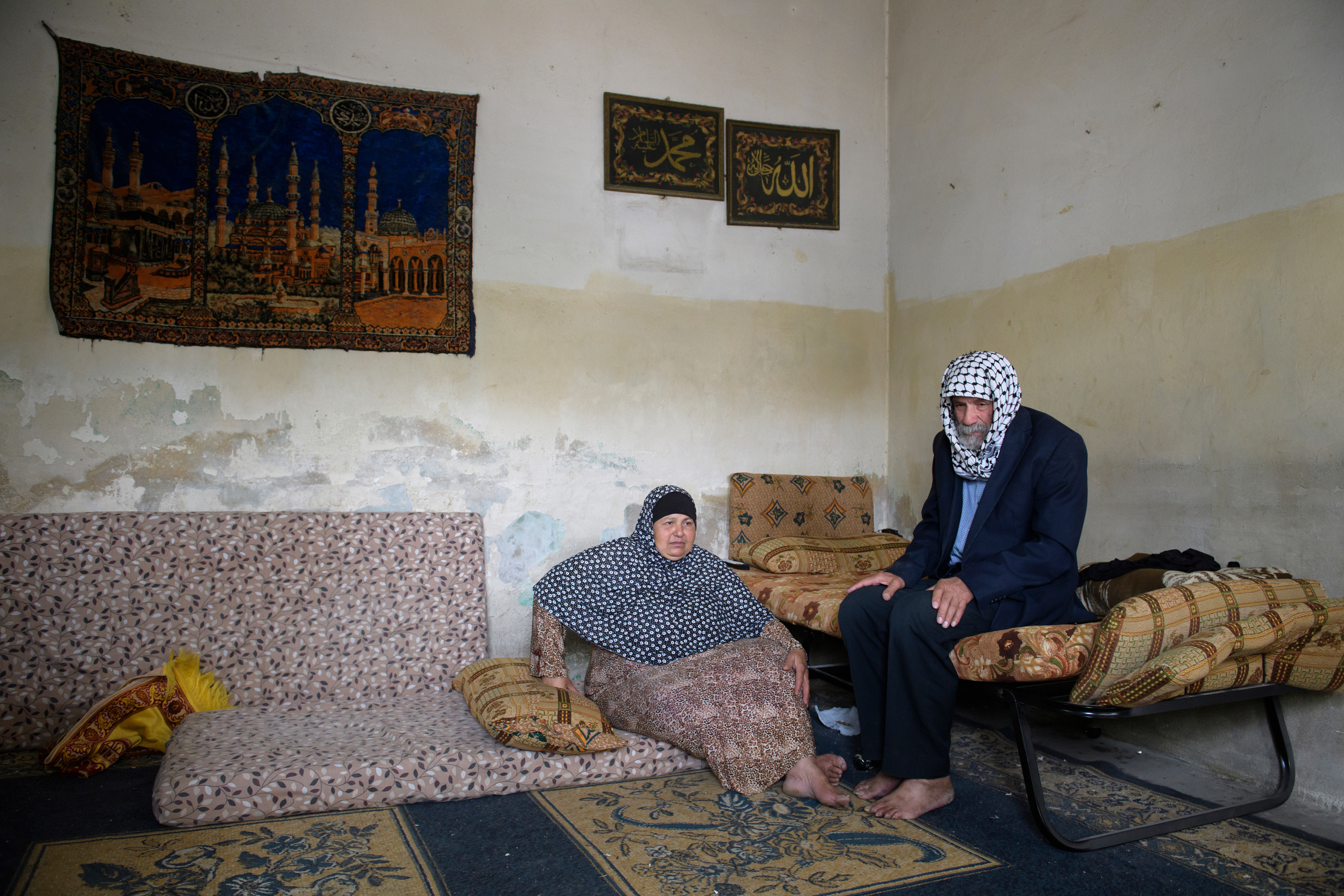 A old man and his wife receiving food parcels from TUA. For this couple without children, having no family and income the only way to be able to eat is to receive the help of this NGO.
A food parcel will be delivered to an endorsed family according to the value of the parcel which in return depends on the number of family members. The food Parcel contains 22 food commodities enough to prepare three meals to the family throughout the month. Currently 30,000 families receive food parcels on monthly basis.
Tkiyet Um Ali (TUA) was founded in 2003 by Her Royal Highness Princess Haya Bint Al-Hussein to represent the first non-governmental organization that seeks to eradicate hunger by providing sustainable food aid through distributing food parcels and serving hot meals at its premises to JordanÕs most unprivileged. Originally conceptualized by Her Late Majesty Queen Alia more than 40 years ago, TUA is inspired by the Islamic concept of providing food for the underprivileged and assuming social responsibility for them. Through this project, Her Royal Highness Princess Haya Bint Al-Hussein continues her motherÕs short lived, yet rich legacy.