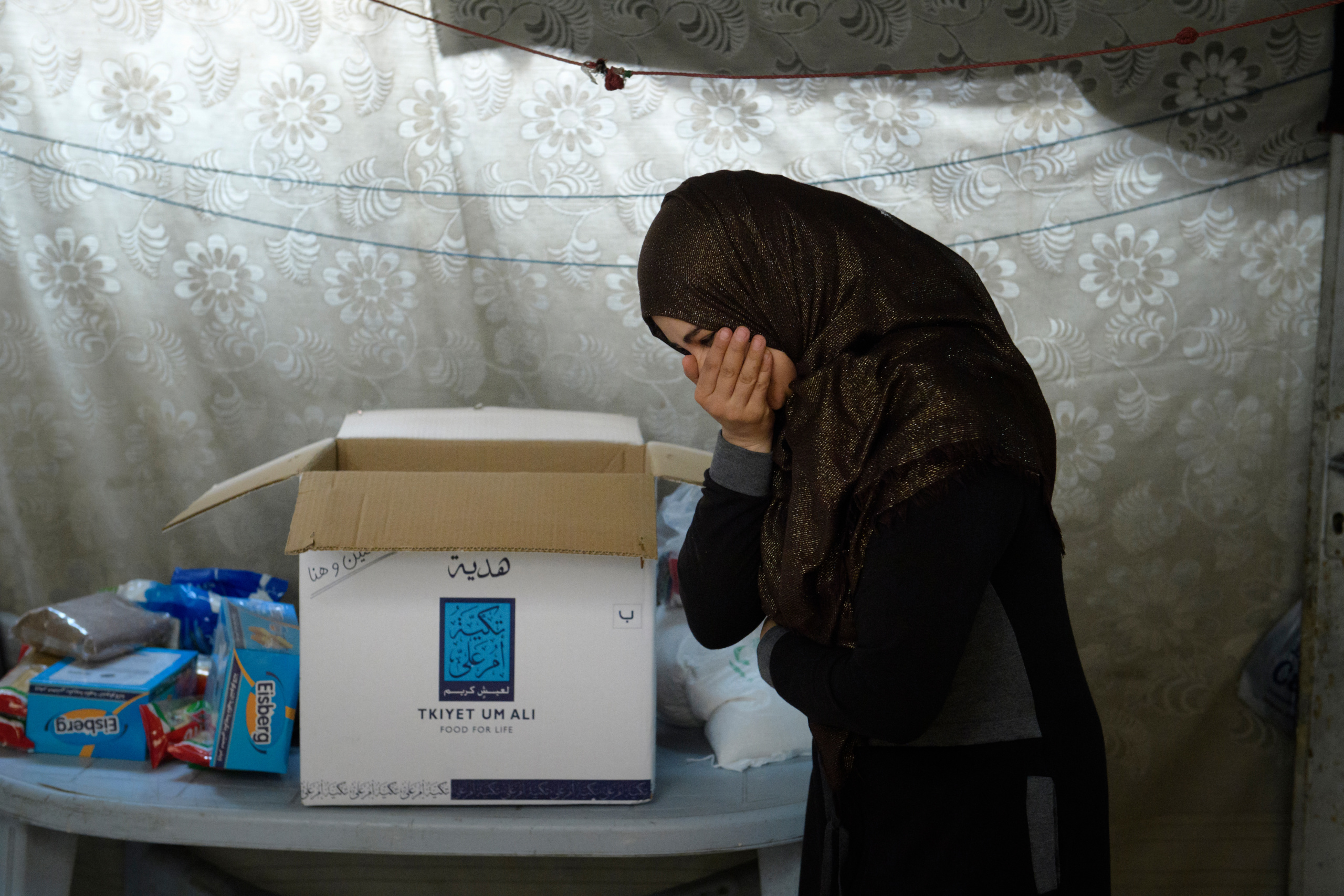 Benificiaries receiving their food parcel from the NGO TUA.
A food parcel will be delivered to an endorsed family according to the value of the parcel which in return depends on the number of family members. The food Parcel contains 22 food commodities enough to prepare three meals to the family throughout the month. Currently 30,000 families receive food parcels on monthly basis.
Tkiyet Um Ali (TUA) was founded in 2003 by Her Royal Highness Princess Haya Bint Al-Hussein to represent the first non-governmental organization that seeks to eradicate hunger by providing sustainable food aid through distributing food parcels and serving hot meals at its premises to Jordan’s most unprivileged. Originally conceptualized by Her Late Majesty Queen Alia more than 40 years ago, TUA is inspired by the Islamic concept of providing food for the underprivileged and assuming social responsibility for them. Through this project, Her Royal Highness Princess Haya Bint Al-Hussein continues her mother’s short lived, yet rich legacy.